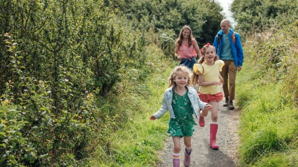 Family walking along coastal path