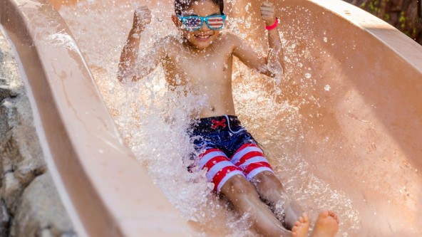 A young boy on a waterslide