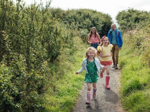 Family walking along coastal path