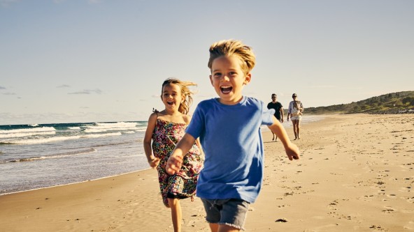 Children running along a beach