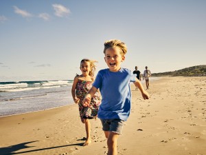 Children running along a beach